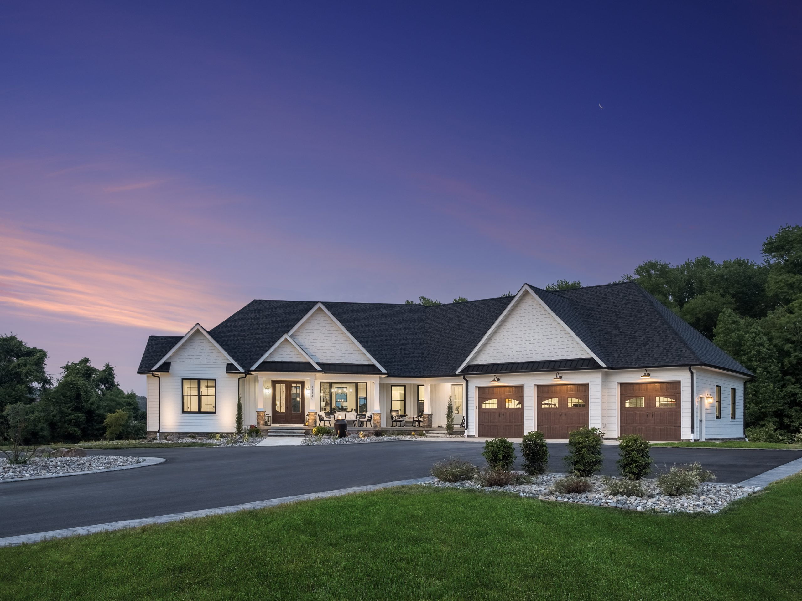 modern white farmhouse at sunset