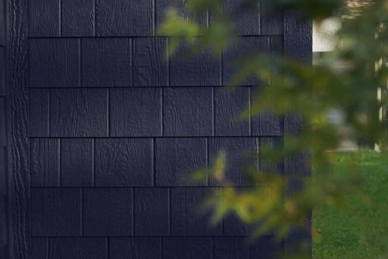 Closeup of a portion of staggered shake siding.